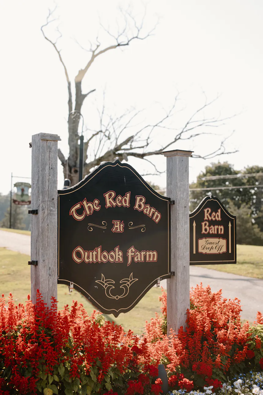 Wildflowers dot the foreground, leading the eye to the striking red barn at tranquil Outlook Farm.
