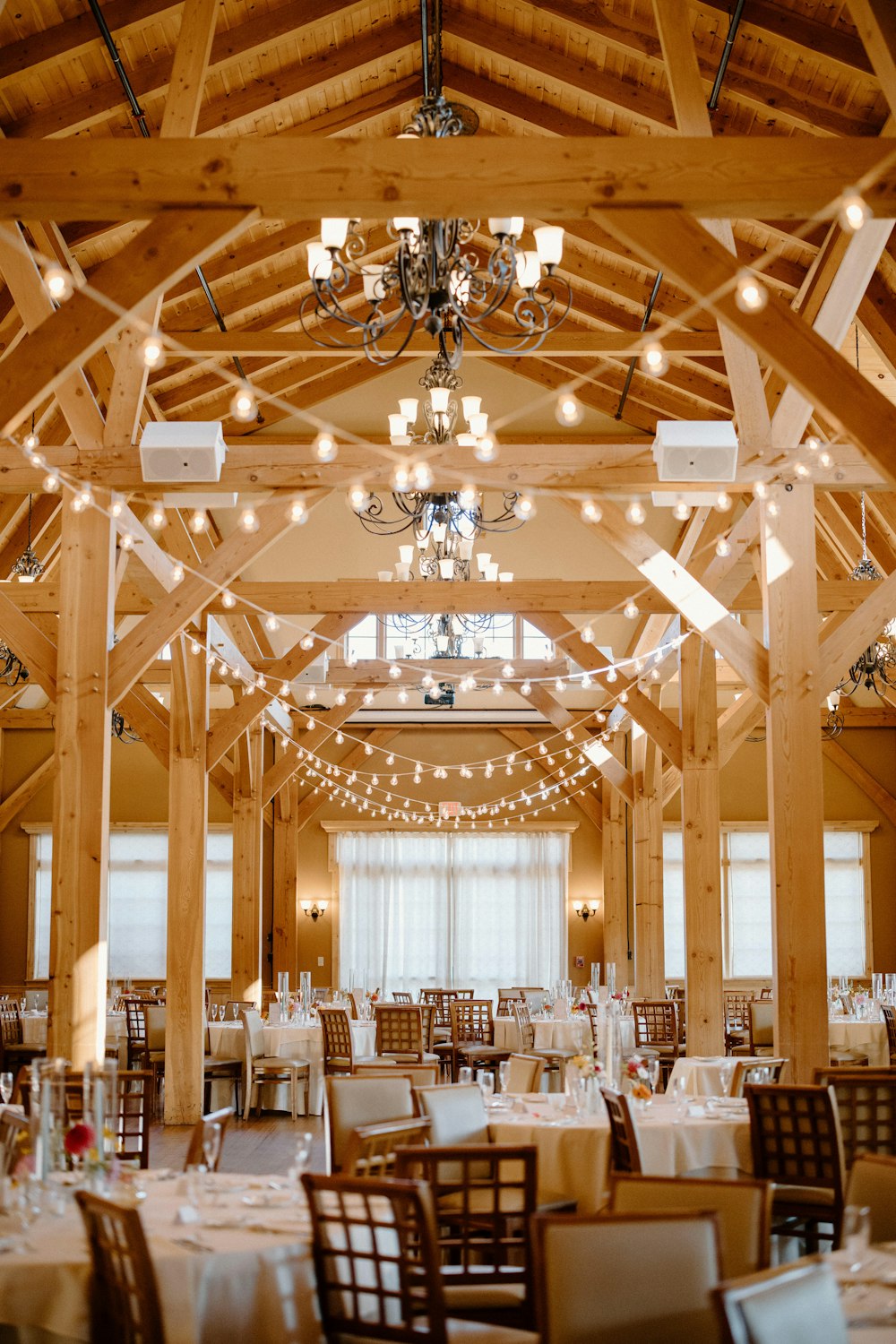 The red barn’s open doors reveal stacked hay bales, showcasing the rustic beauty of traditional Outlook Farm life.